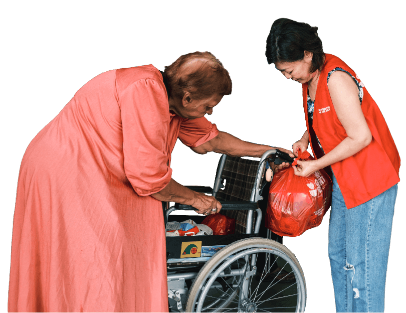 Volunteer helping elderly person in wheelchair